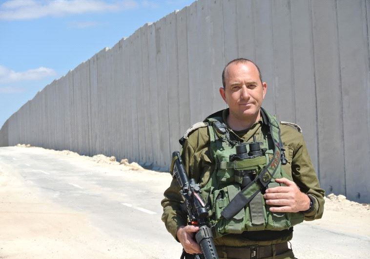Battalion commander Lt. Col Tsafrir Harshoshanim stands along the new fence being built on the Lachish region border with Hebron hills. 