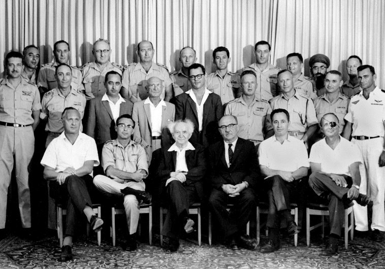 Then-Defense Ministry director-general Shimon Peres (seated second right) attends a meeting of the IDF General Staff with prime minister David Ben-Gurion in 1961. Peres is sitting between then-finance minster Levi Eshkol and then-agriculture minister Moshe Dayan (photo credit: GPO)