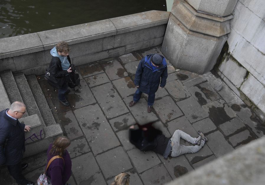 A man lies injured after a shooting incident on Westminster Bridge in London, March 22, 2017 (Reuters)