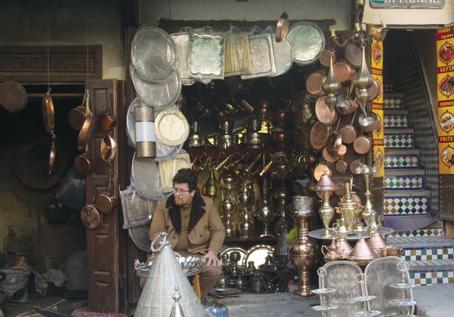 A merchant sits in front of a brassware shop in the Fez medina. Credit: Sarah Levi