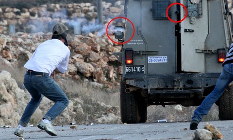 Tamimi (left) a moment before his injury; ; Emphasis on barrels added by Popular Struggle Coordination Committee.