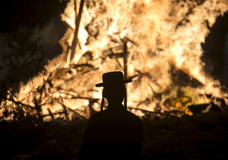Orthodox man stands in front of a bonfire in Bnei Brak (Photo by: Reuters)