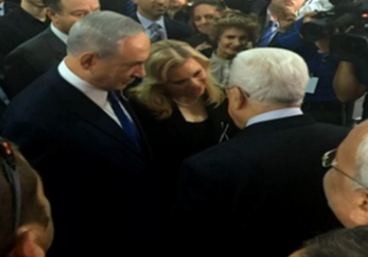 PM Netanyahu greets PA President Abbas at Peres funeral service. Photo by: Medan Osnat