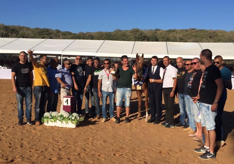 "Nabella Ajman" a champion horse strikes a pose with her owners and trainers