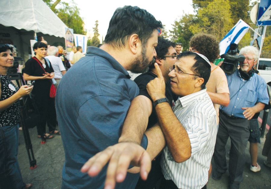 A settlement supporter (right) gestures as he argues with a left-wing activist in Jerusalem. Credit: Reuters